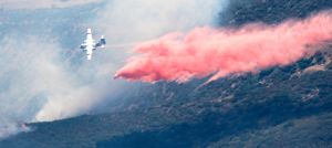 Firefighting plane drops retardant. 